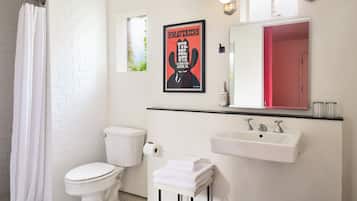 A bathroom with a toilet, sink, and shower curtain.