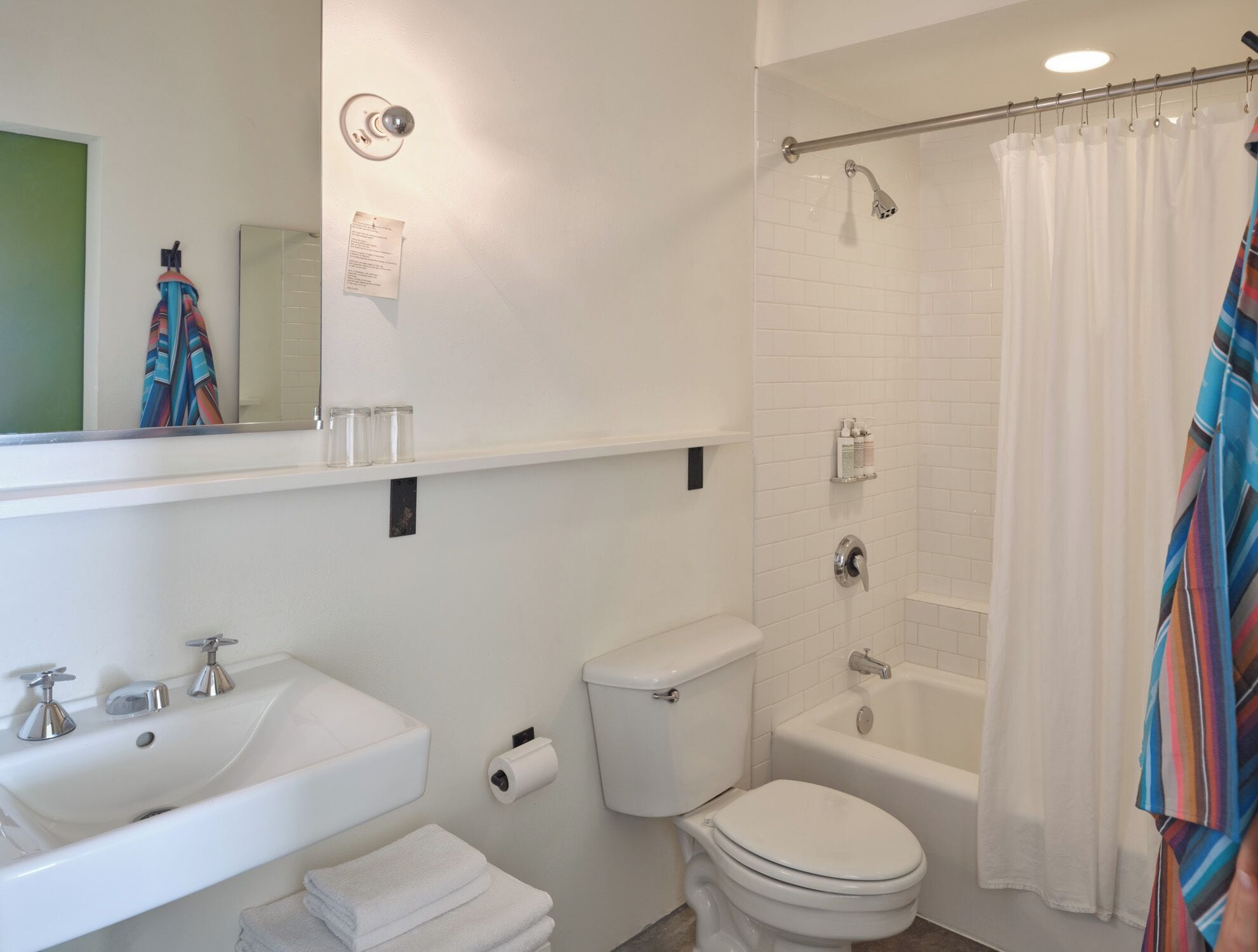 A modern bathroom with a sink, toilet, bathtub, and shower.