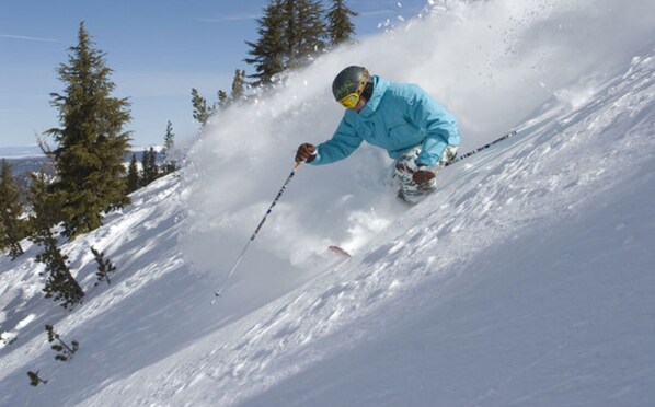 A person skiing down a snowy slope. - Ritz on the Ridge. A Gem of a Stay & Guest Favorite! (Mammoth Lakes)