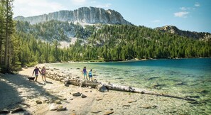 A clear lake with a forested mountain in the background. - Ritz on the Ridge. A Gem of a Stay & Guest Favorite! (Mammoth Lakes)