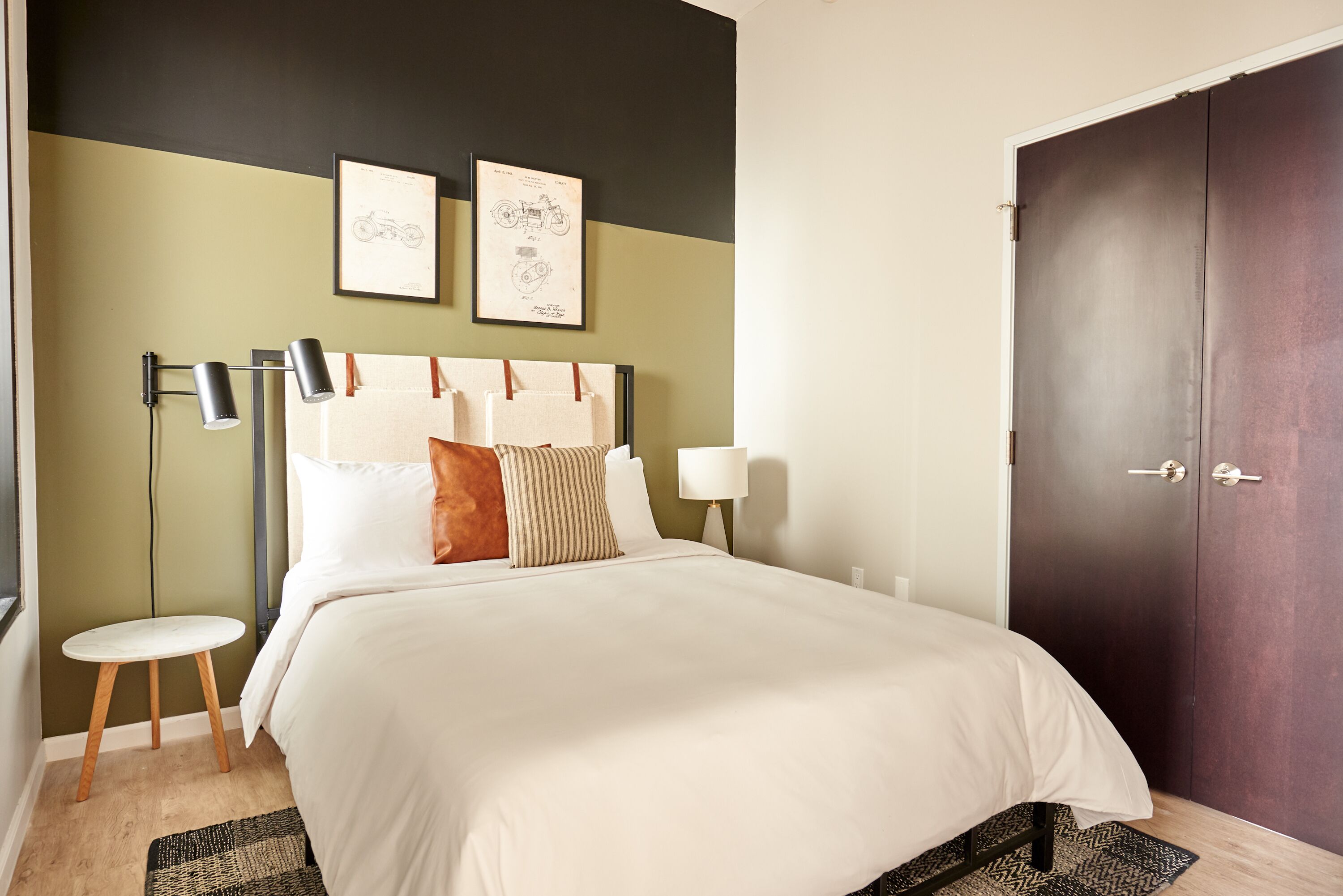 A neatly arranged bedroom with a bed, bedside tables, and a wardrobe.