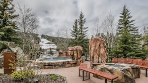 A park with benches, a hot tub, and a rocky landscape. - Springs 8819 (Keystone)
