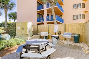 Enjoy outdoor dining and cooking on the patio with picnic tables and a barbecue grill.