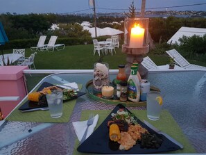 A table set for dinner with various dishes, drinks, and condiments. - Bermuda Connections Guest House (Southampton Parish)
