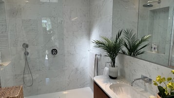 Bathtub, eco-friendly toiletries, hair dryer, towels