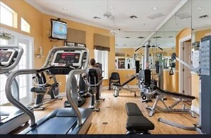 A gym with treadmills, a bench, and various exercise machines.