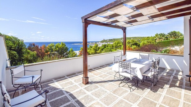 A terrace with a pergola, outdoor seating, and a view of the sea and greenery. - 2 bedroom gorgeous home in Nardò (Nardò)