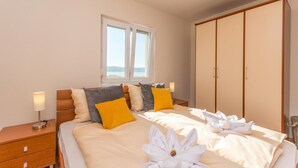 A hotel room with a bed, bedside tables, a wardrobe, and a window with a view. - Awesome home in Turanj (Turanj)