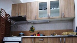 Una cocina con armarios de madera, estufa y microondas.