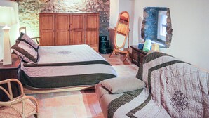 A room with two beds, a wooden wardrobe, a mirror, a chair, and a television. - Nice home in Thueyts with WiFi (Thueyts)