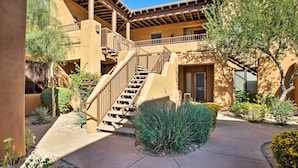 A building with a central staircase, multiple balconies, and a courtyard with various plants. - Pool Access, Views: 'Scottsdale Serenity' Condo! (Scottsdale)