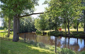 Surrounded by lush greenery and a serene water body, this peaceful retreat offers a tranquil escape.