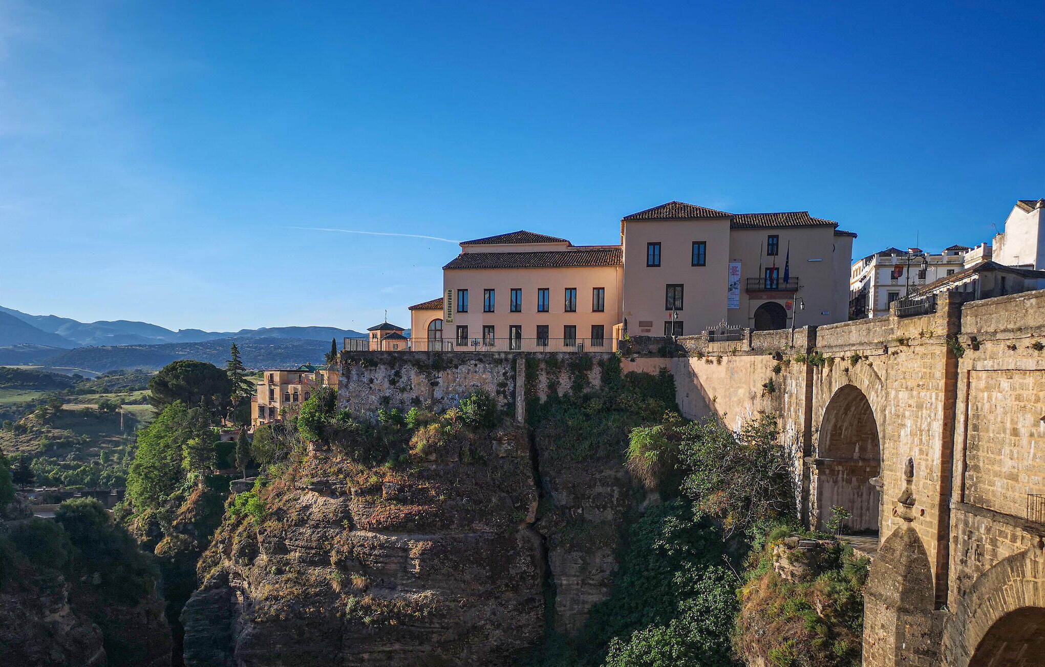 A historic building with a stone bridge and a view of the surrounding landscape.