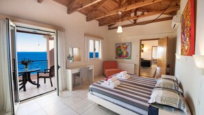 A bedroom with a bed, a desk, a chair, and a view of the sea. - Gorgeous home in Lefkada with private swimming pool, can be inside or outside (Lefkada)