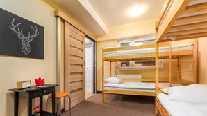 A dormitory room with bunk beds, a desk, and a chair. - Luxhostel24 Warsaw (Warsaw)