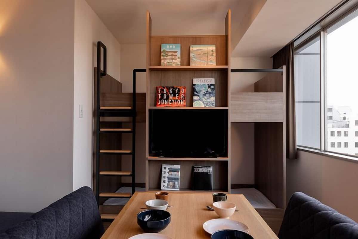 Ein zeitgemäßer Wohnraum mit Sofa, Esstisch und Bücherregalen.