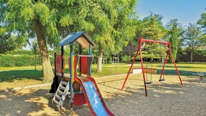 A playground with a slide, swings, and climbing structures.