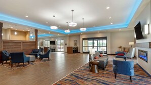 A spacious lobby with modern furniture, a patterned carpet, and a large window offering natural light. - Comfort Suites Dry Ridge (Dry Ridge)