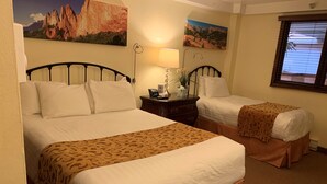 A hotel room with two beds, a nightstand with a lamp, and two paintings on the wall. - Christmas Skiing at Vail, Just minutes away from the slopes and restaurants (Vail)