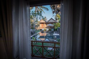 Family Double Room, Pool View | Living area | 32-inch flat-screen TV with cable channels, TV, pay films - The Wood Family Retreat (Siem Reap)