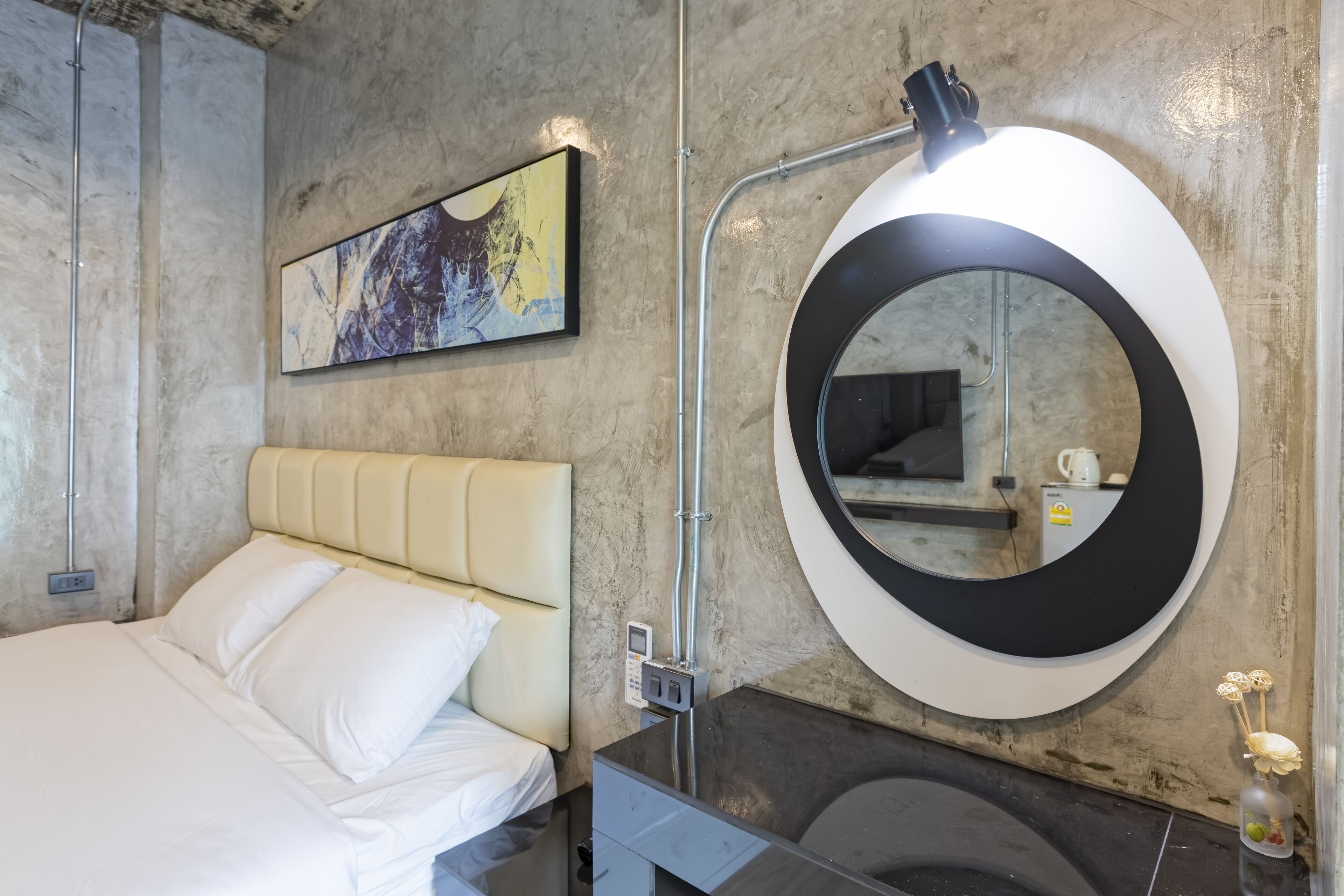 Un baño moderno con un espejo grande, inodoro y lavabo.