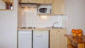 A compact kitchen with a microwave, sink, and two dishwashers. - Les Genepis (Val Claret) by Interhome (Tignes)