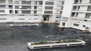 A multi-story building with a central courtyard, balconies, and a sign indicating a sports facility. - Bay Inn (Tirukalukundram)