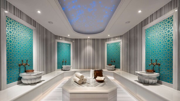 A luxurious bathroom with a central marble sink, two side sinks, and a ceiling with a starry light display. - Radisson Blu Hotel, Sakarya (Arifiye)