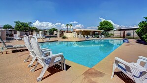A swimming pool with lounge chairs and a fence. - Beautiful CLEAN Townhome in East Mesa -  w/Community Heated Pool (Mesa)