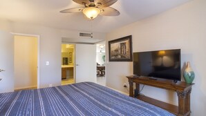 A bedroom with a large bed, a television, and a decorative vase. - Beautiful CLEAN Townhome in East Mesa -  w/Community Heated Pool (Mesa)