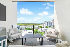 A balcony with a view of buildings and a clear sky. - Direct Collective - Rhythm on Beach (Maroochydore)