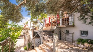 A staircase leading to a balcony with outdoor seating and plants. - Nice apartment in Stara Baska with WiFi (Stara Baska)