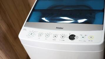 A Haier washing machine with a digital display and multiple control buttons.