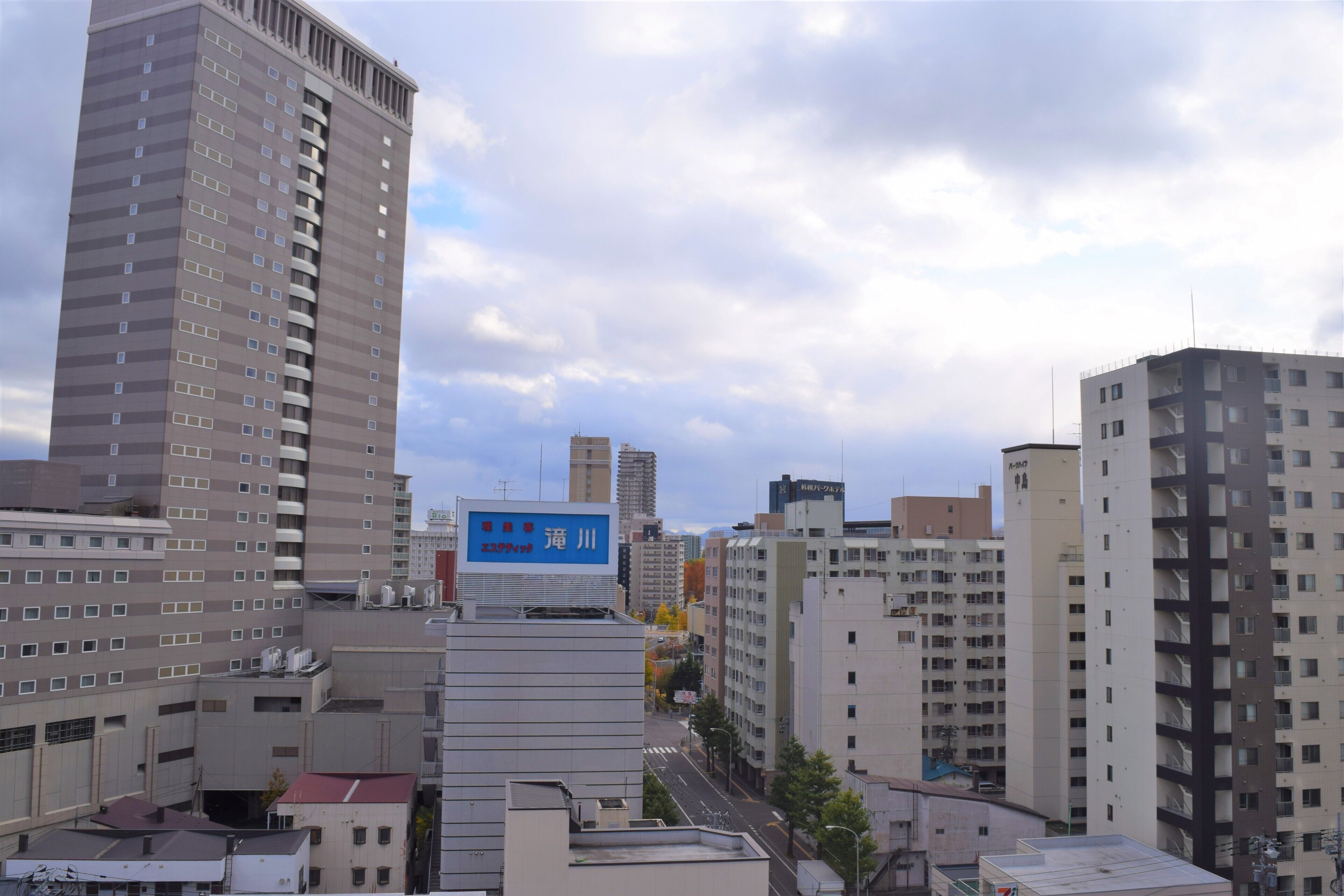 A high-rise urban building complex with multiple floors and balconies.