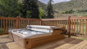 A hot tub on a wooden deck with a view of a hilly landscape. - ☞Sunny & Spacious 2 King 2 Queen in the heart of the Vail❅Valley⛷ (Avon)