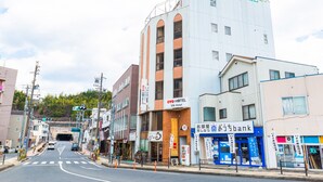 A hotel with a sign reading "OYO HOTEL Silk Hotel" and a bank with a sign reading "Omo Department Store Bank".