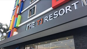 The exterior of The TJ Resort with a colorful facade and a large glass entrance. - The TJ Resort (Pattaya)