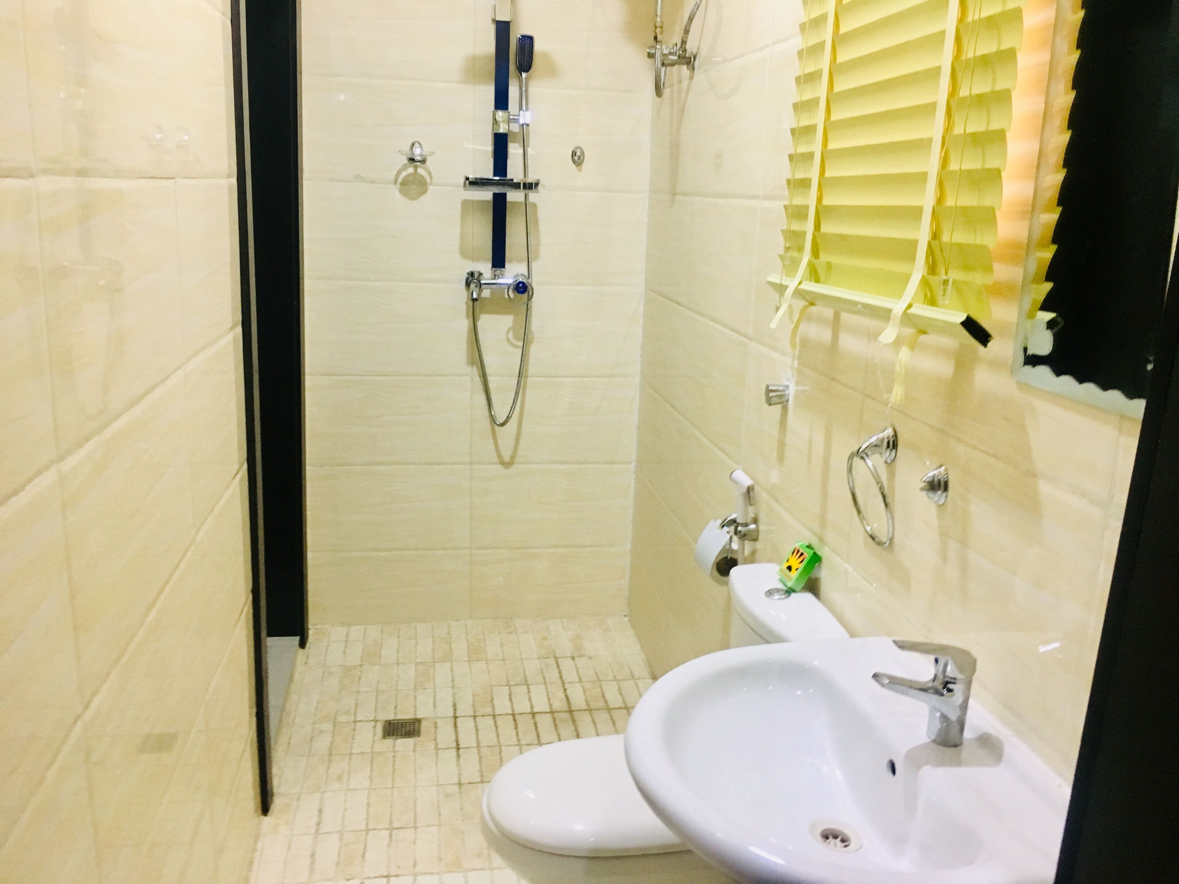 A bathroom with a toilet, sink, and shower.