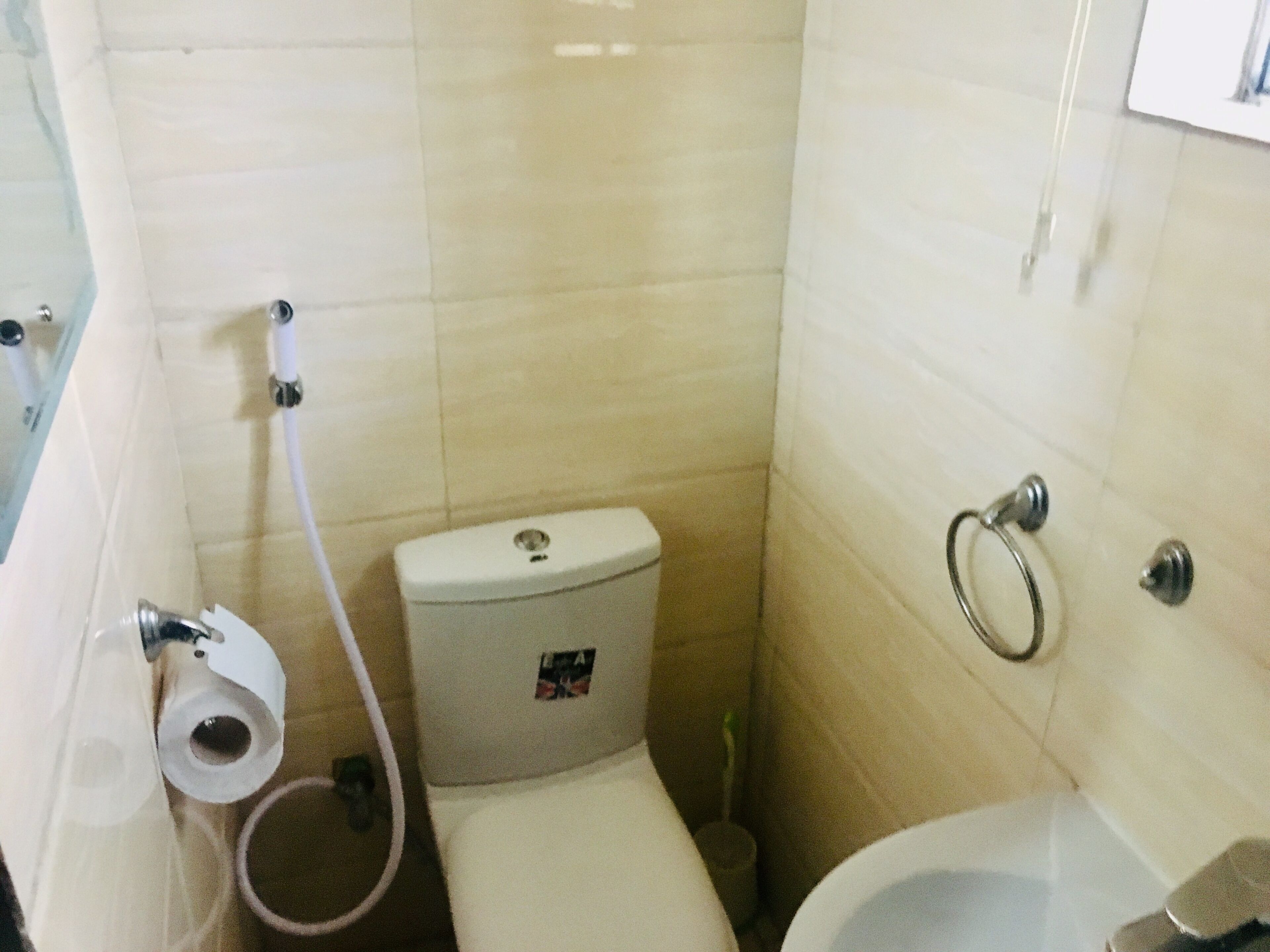 A small bathroom with a toilet, a bidet, and a sink.