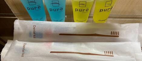 A dental kit and four tubes of Pure Vitality bath gel and shampoo.