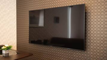 A flat-screen TV mounted on a textured wall.