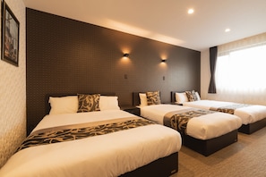 A hotel room with three beds, dark patterned headboards, and wall-mounted lighting. - GRAND BASE Nagasaki Ekimae (Nagasaki)