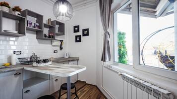 Mini-fridge, stovetop, electric kettle, cookware/dishes/utensils