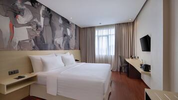 A modern hotel room with a large bed, a flat-screen TV, a desk with a chair, and a large window with curtains.