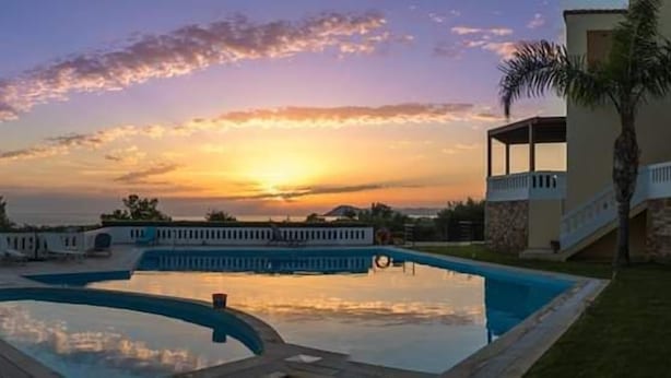 A swimming pool with a sunset view, a covered area, and a staircase leading to a building. - Villa Pandora - Angela & Michali (Platanias)