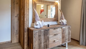 A rustic wooden vanity with a large mirror, two sconces, and a gnome decoration. - Cozy Chalet - 1 BR - 4 Pers - Terrace - Parking (La Clusaz)