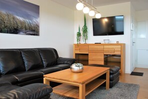 Apartment, 2 Bedrooms, Balcony | Living room | Flat-screen TV, DVD player