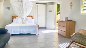 A bedroom with a bed, bedside table, and a wardrobe.