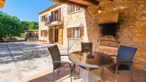 A stone building with a balcony, outdoor seating area, and a fireplace. - CAN MOLETA  Finca for 8 people near Porto Cristo (Manacor (Porto Cristo))