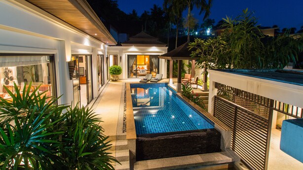 A modern house with a swimming pool, a covered patio, and a well-lit interior. - Tulip Pool Villa (Rawai)